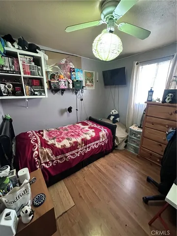 a bedroom with bed and a chandelier