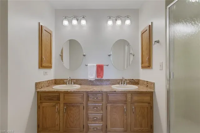 a bathroom with a double vanity sink and a mirror