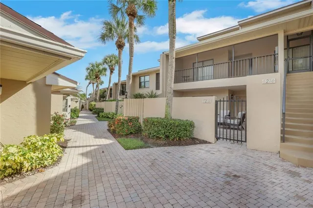 a view of a house with a yard and potted plants