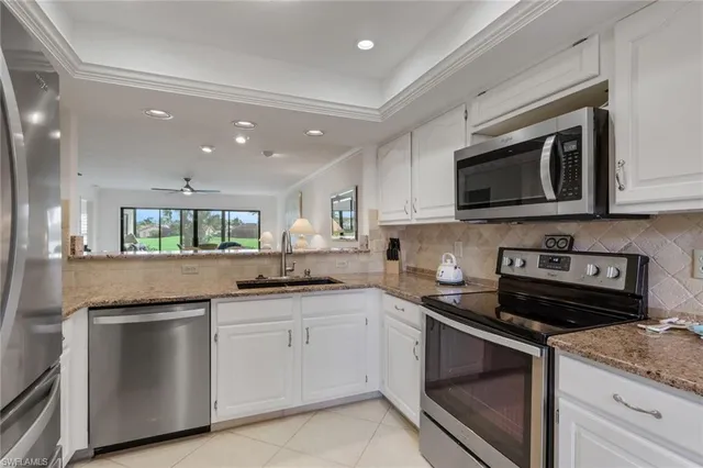 a kitchen with appliances cabinets and a sink