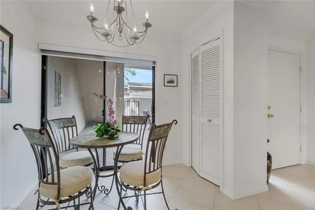 a view of a dining room with furniture and chandelier