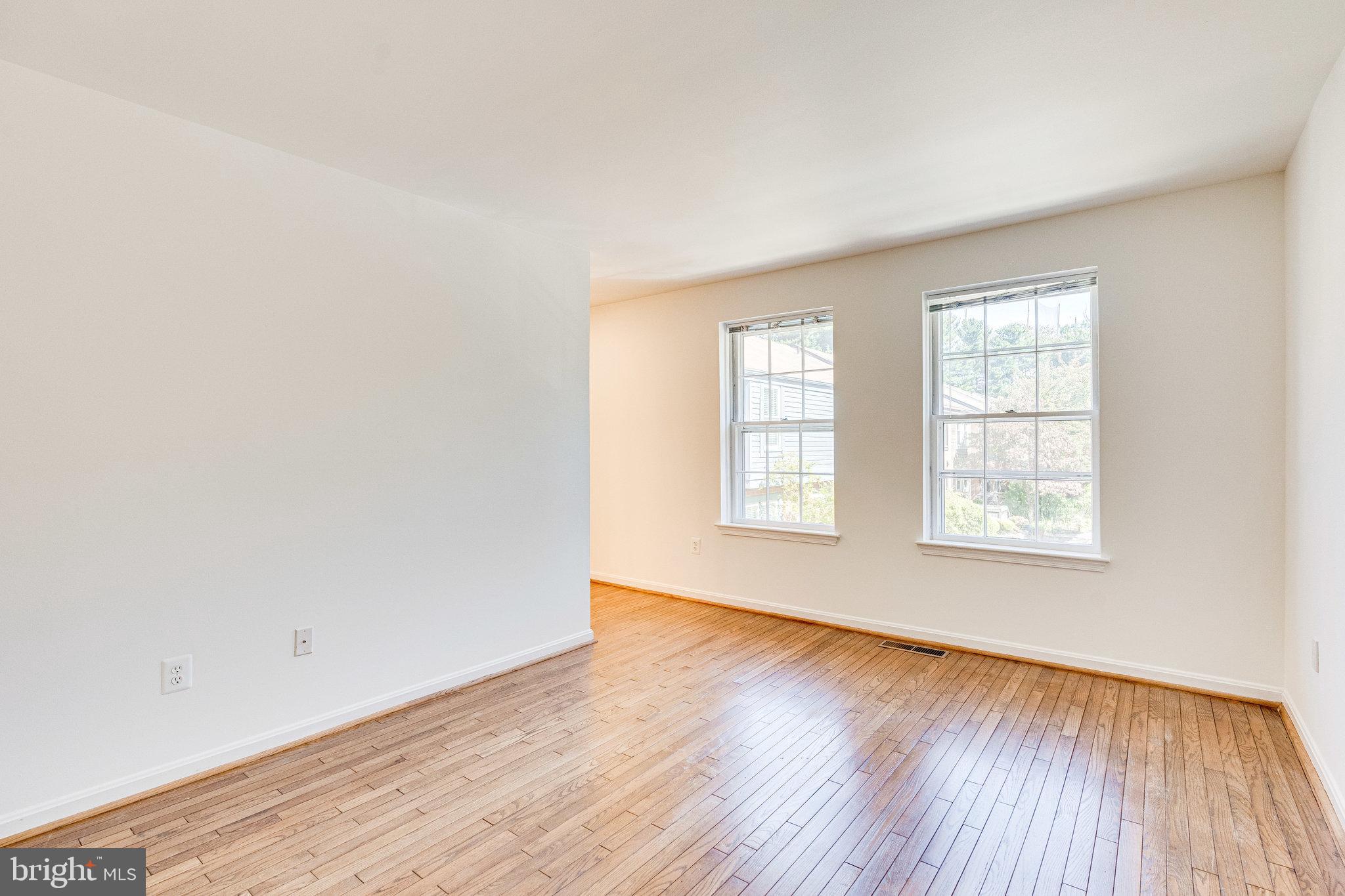 2186 Golf Course Drive Reston, VA 20191 - Photo 13 of 36 an empty room with wooden floor and windows