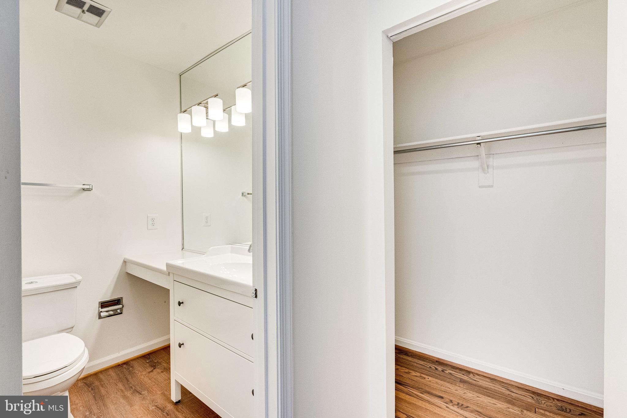 2186 Golf Course Drive Reston, VA 20191 - Photo 14 of 36 a bathroom with a granite countertop sink toilet and shower