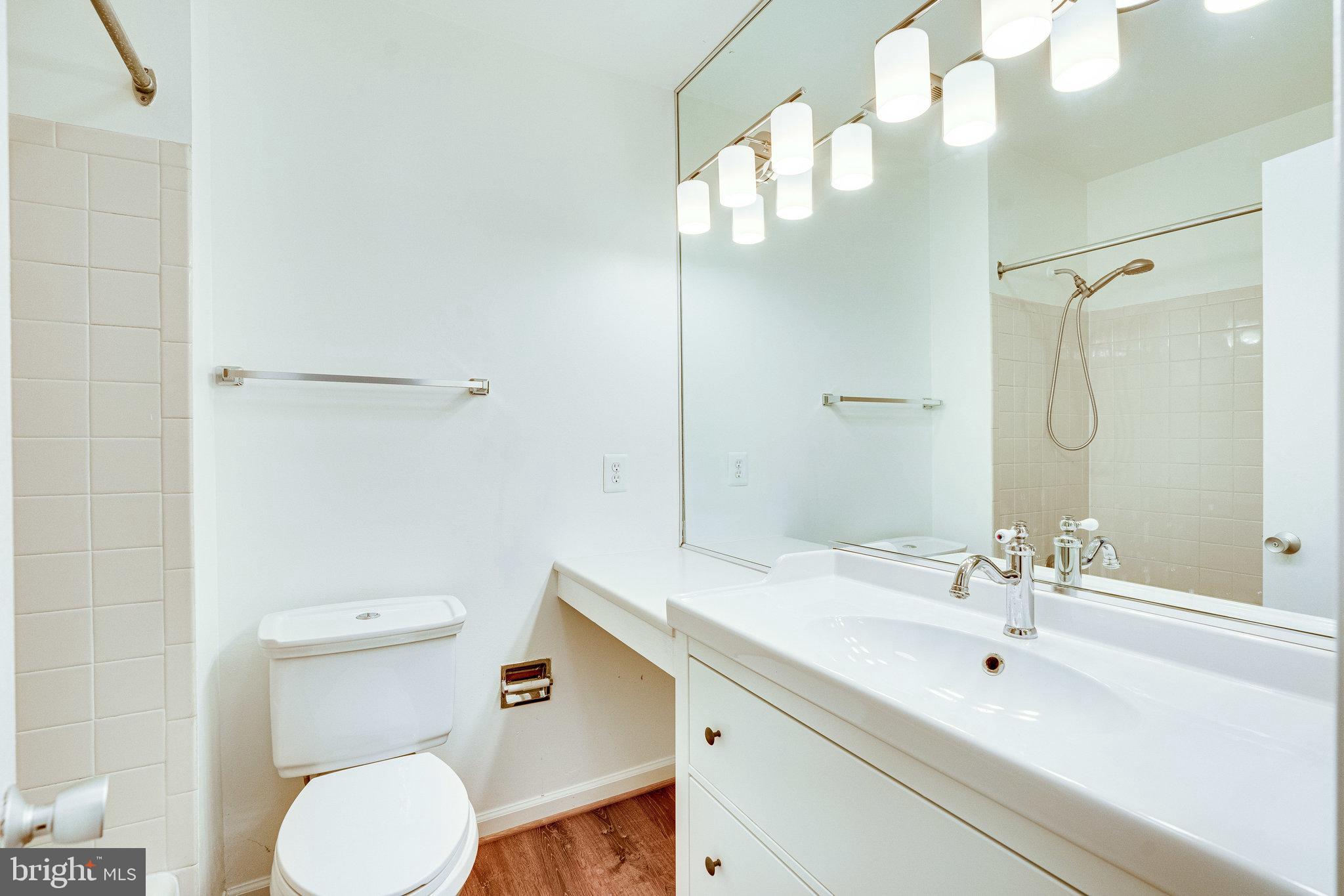 2186 Golf Course Drive Reston, VA 20191 - Photo 15 of 36 a bathroom with a sink a toilet and shower