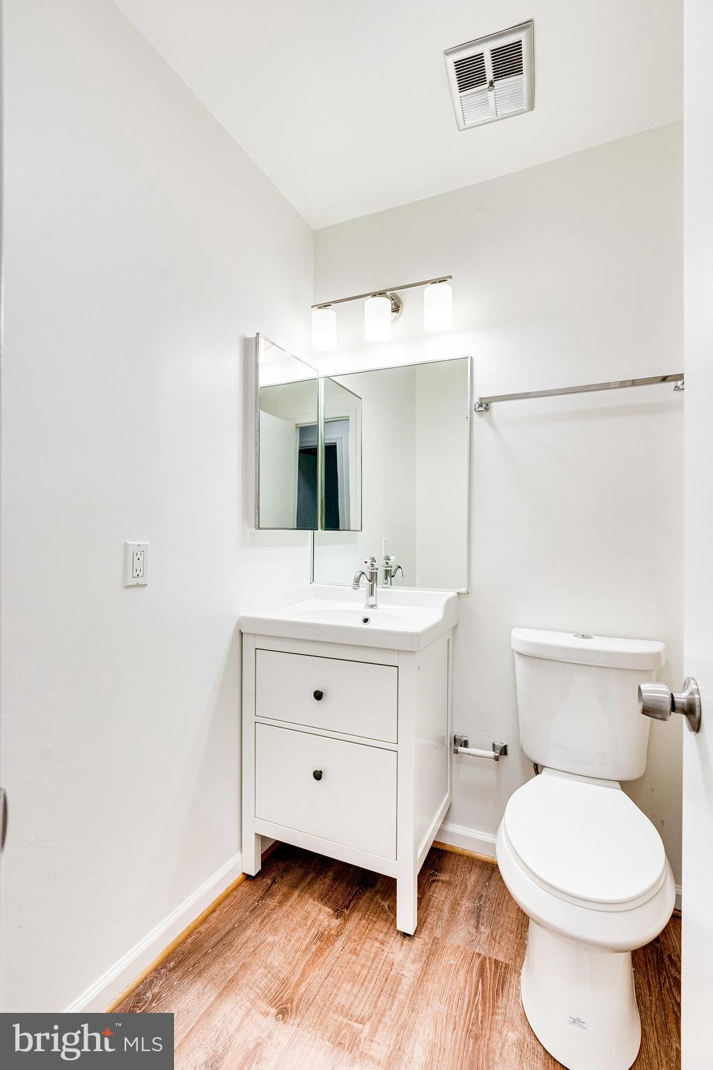 2186 Golf Course Drive Reston, VA 20191 - Photo 17 of 36 a bathroom with a sink mirror vanity and toilet