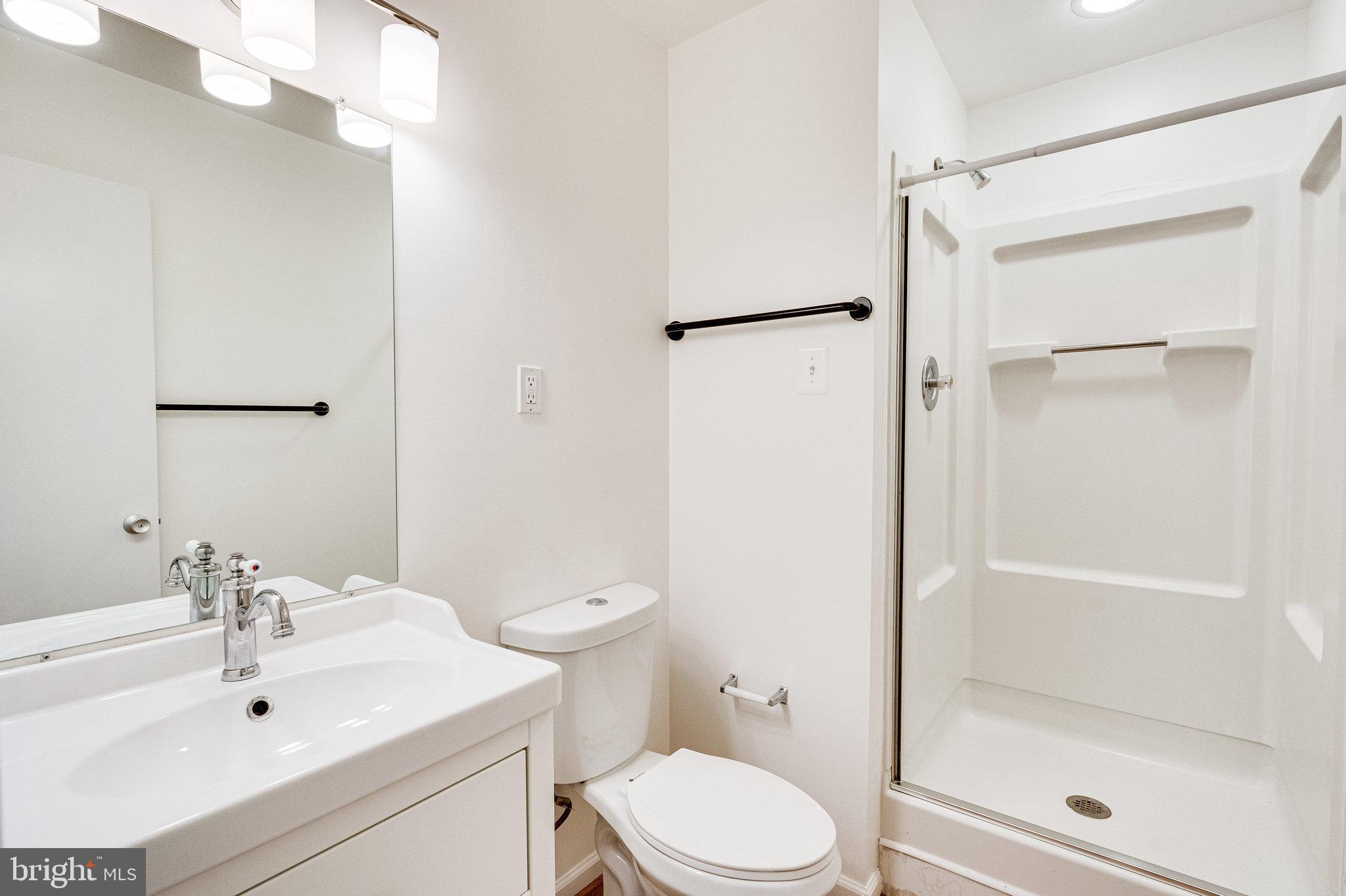 2186 Golf Course Drive Reston, VA 20191 - Photo 20 of 36 a bathroom with a sink toilet and shower