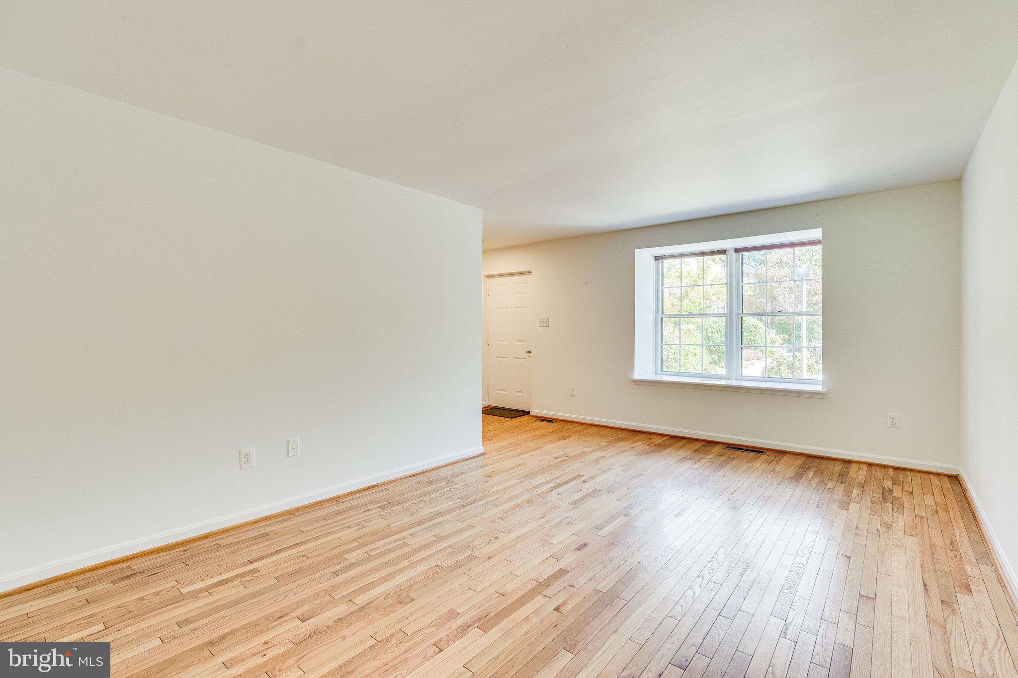 2186 Golf Course Drive Reston, VA 20191 - Photo 3 of 36 an empty room with wooden floor and windows
