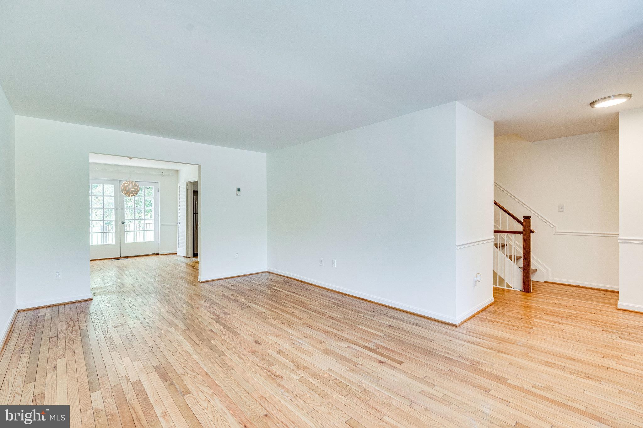 2186 Golf Course Drive Reston, VA 20191 - Photo 4 of 36 a view of an empty room with wooden floor and a window