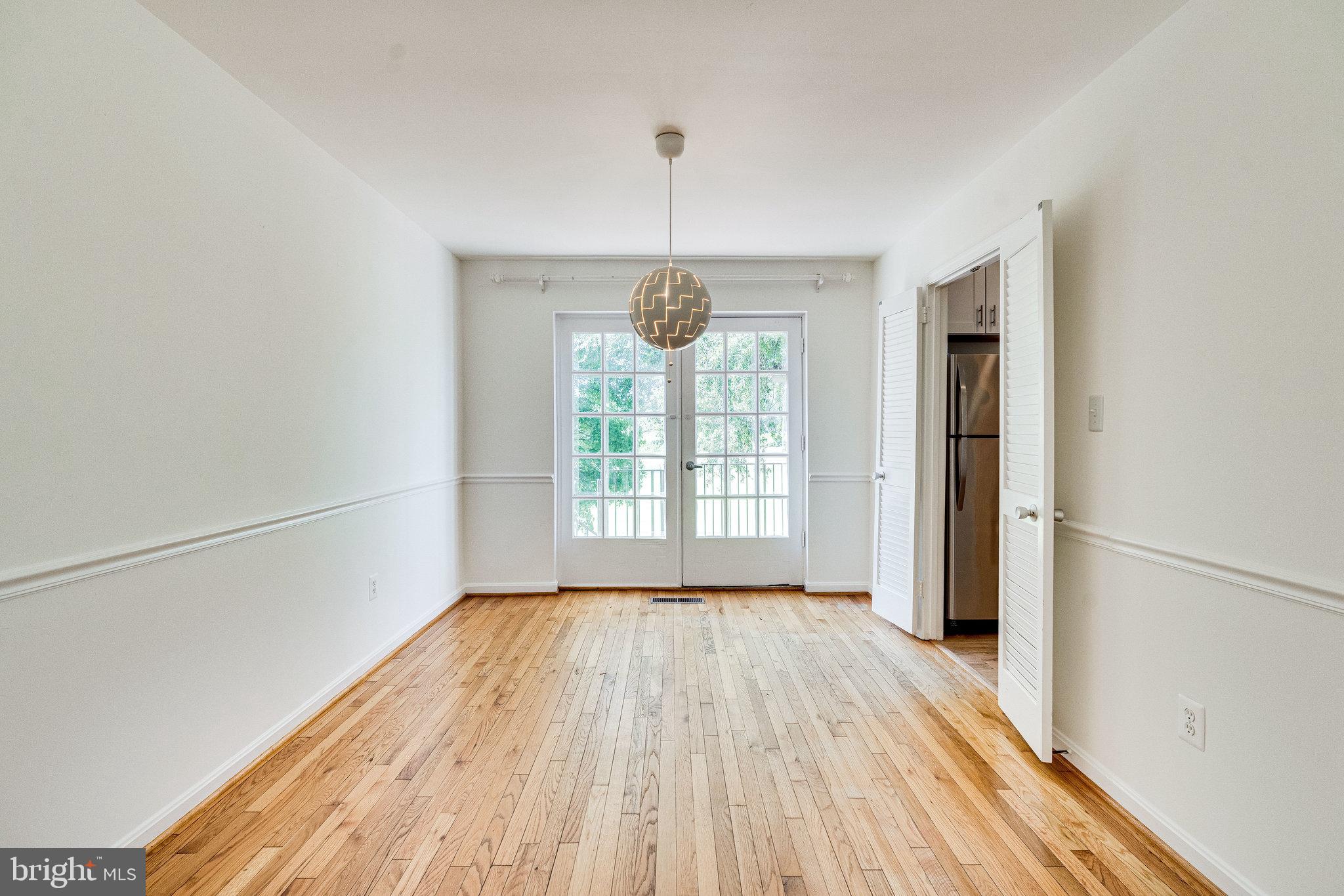 2186 Golf Course Drive Reston, VA 20191 - Photo 5 of 36 a view of an empty room with wooden floor and a window