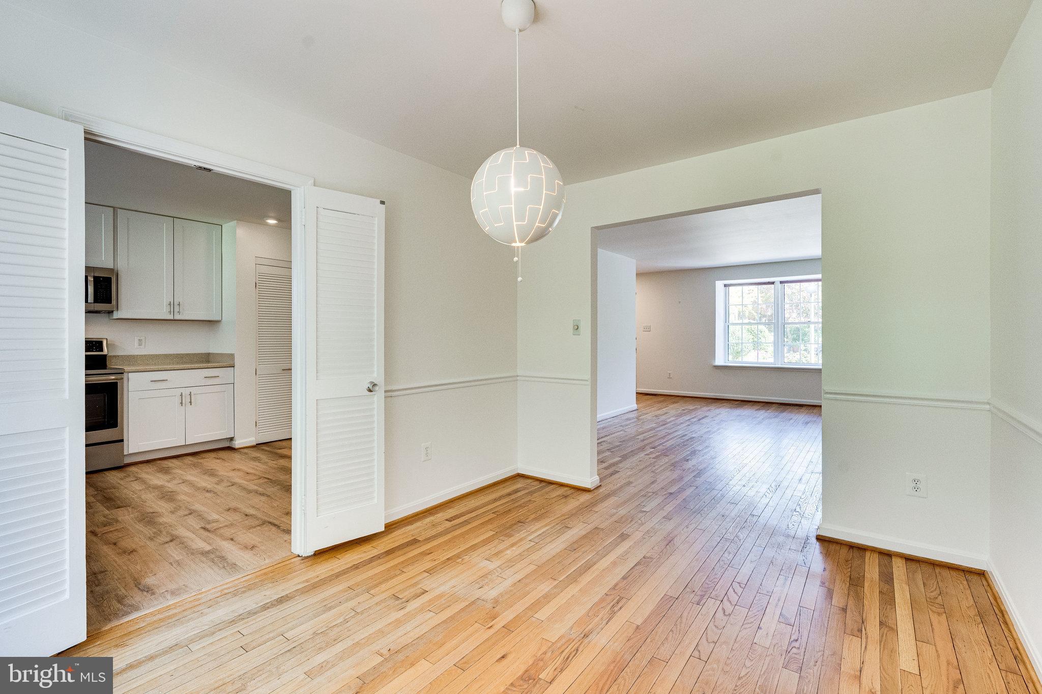 2186 Golf Course Drive Reston, VA 20191 - Photo 6 of 36 a view of a room with wooden floor window and a kitchen space