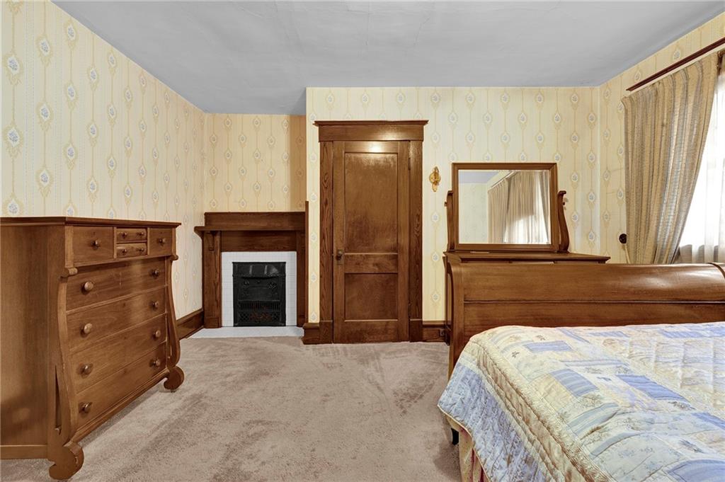 631 Riverview Road Freedom, PA 15042 - Photo 23 of 43 a bedroom with a bed and a fireplace