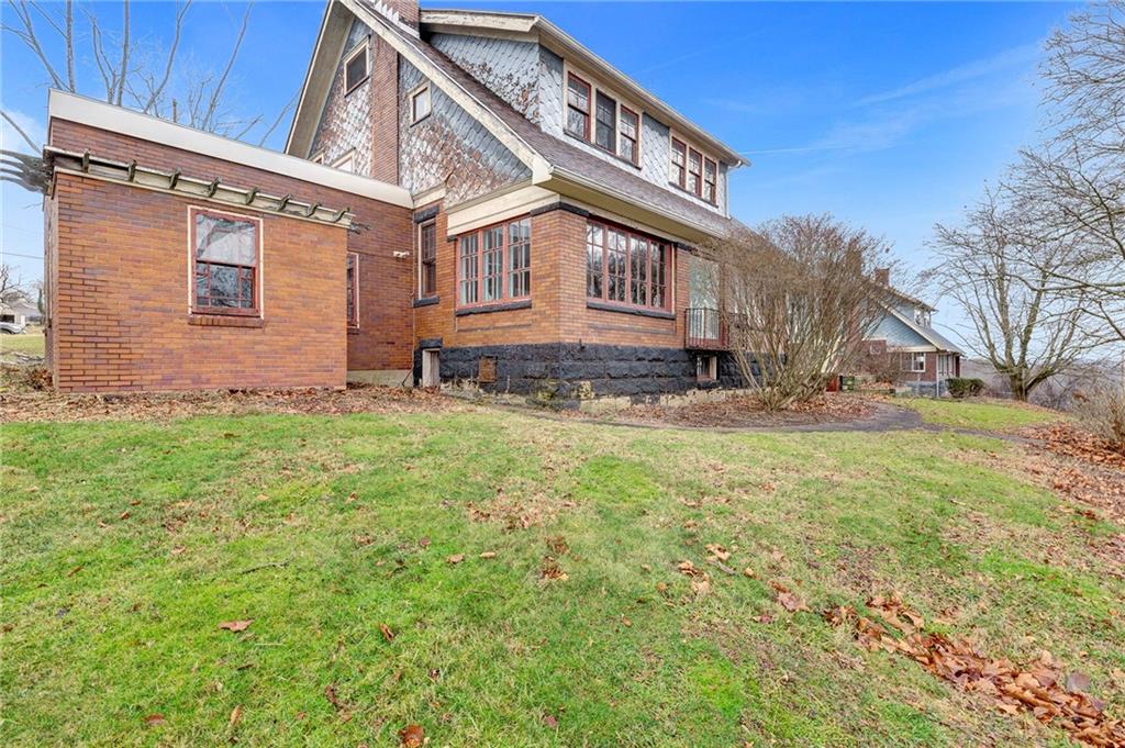 631 Riverview Road Freedom, PA 15042 - Photo 32 of 43 a view of a house with a yard and lawn chairs