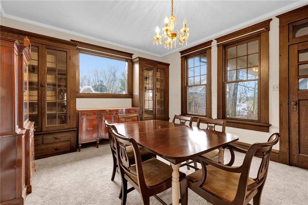 631 Riverview Road Freedom, PA 15042 - Photo 8 of 43 a dining room with furniture a chandelier and wooden floor