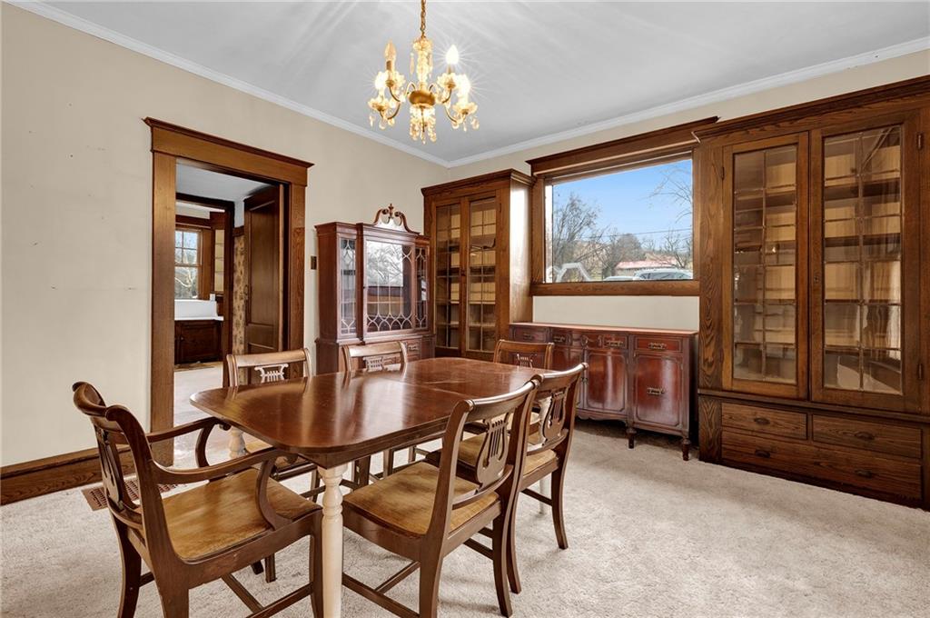631 Riverview Road Freedom, PA 15042 - Photo 9 of 43 a dining room with furniture a large window and a chandelier