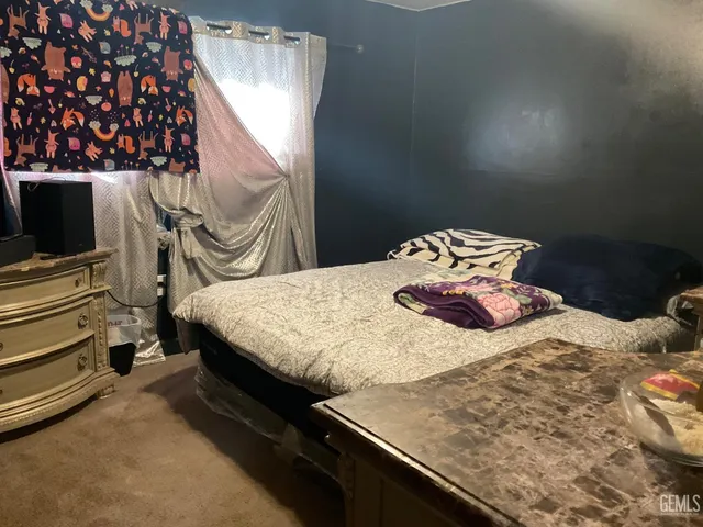 a bedroom with a bed and flat screen tv