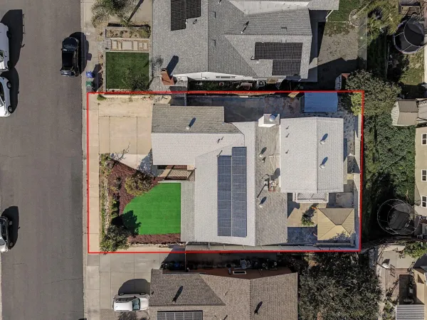 an aerial view of a house with outdoor space