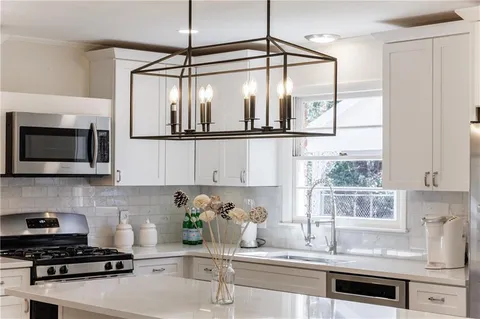 a kitchen with a sink cabinets and window