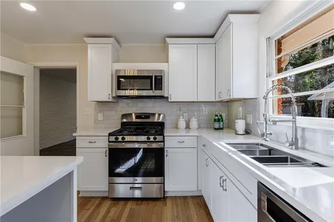 a living room with furniture a rug and a large window