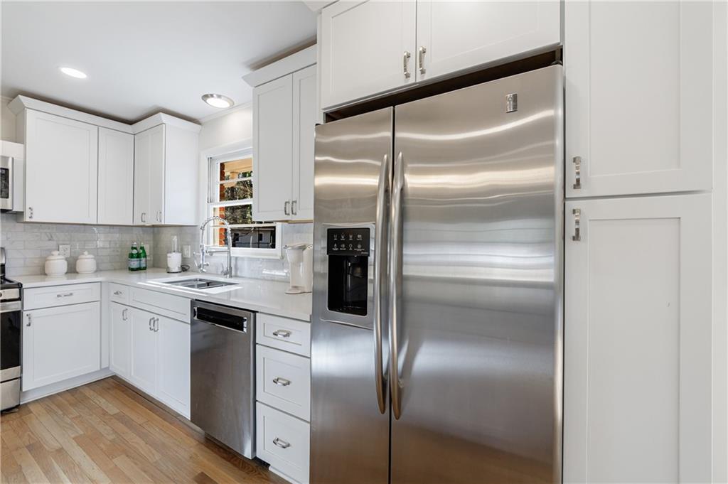 2996 Arrowood Drive East Point, GA 30344 - Photo 14 of 63 a kitchen with cabinets and stainless steel appliances