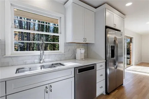 a living room with furniture and kitchen view