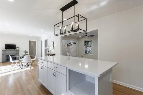 a dining room with furniture and wooden floor