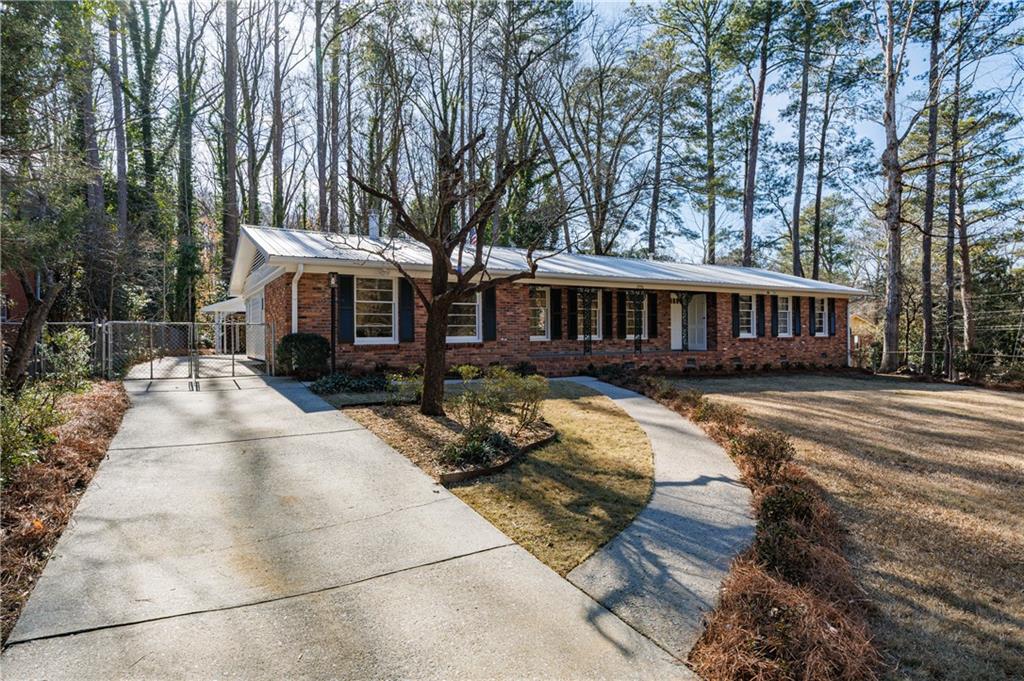 2996 Arrowood Drive East Point, GA 30344 - Photo 2 of 63 a view of a white house with a large trees and yard and swimming pool