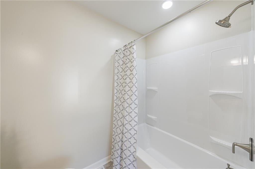 2996 Arrowood Drive East Point, GA 30344 - Photo 32 of 63 a bathroom with a shower curtain and a shower curtain