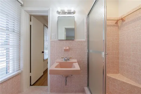 wooden floor in an empty room with a bathroom