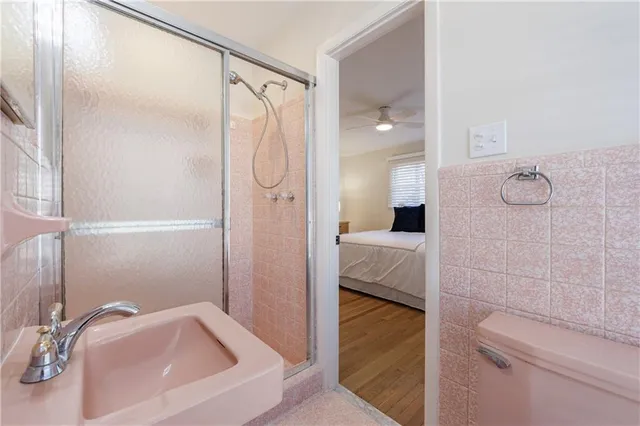 a bathroom with a granite countertop sink mirror vanity and toilet