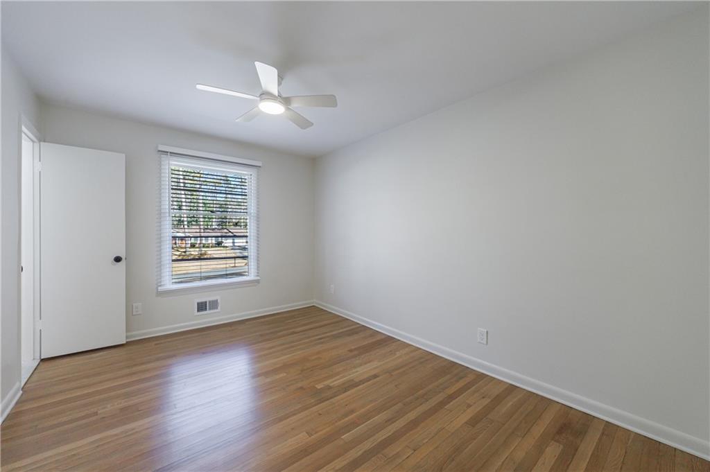 2996 Arrowood Drive East Point, GA 30344 - Photo 41 of 63 an empty room with wooden floor and windows
