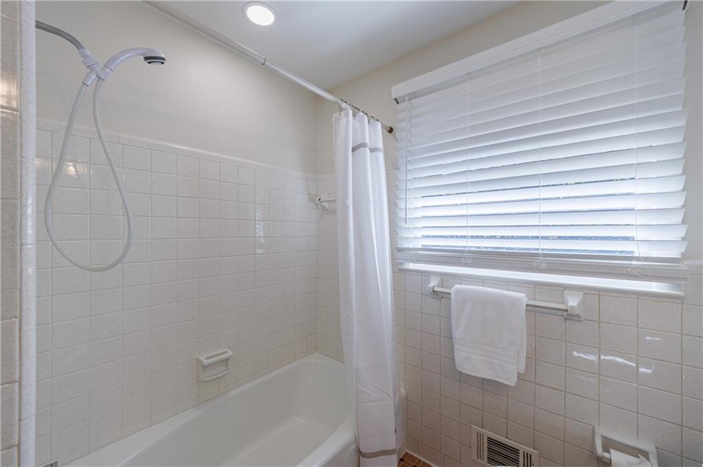 2996 Arrowood Drive East Point, GA 30344 - Photo 44 of 63 a bathroom with a shower and a bathtub