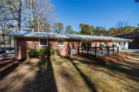 a view of a roof deck with wooden fence and trees