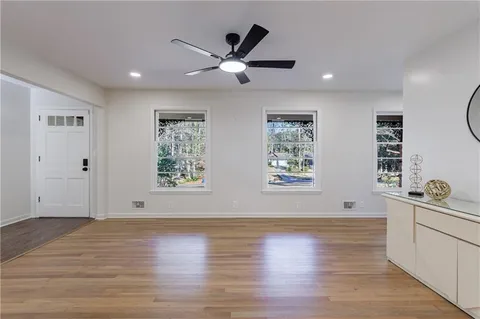 a kitchen with stainless steel appliances granite countertop a refrigerator a stove oven a sink dishwasher and a refrigerator with wooden floor