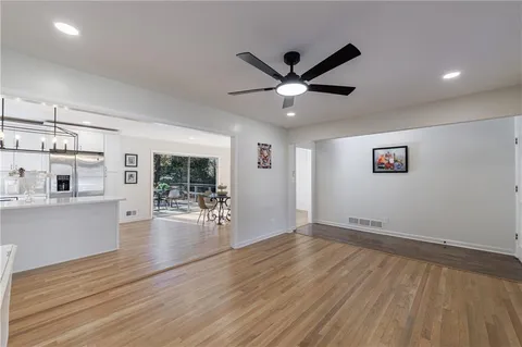a view of a kitchen with stainless steel appliances granite countertop a stove and a sink
