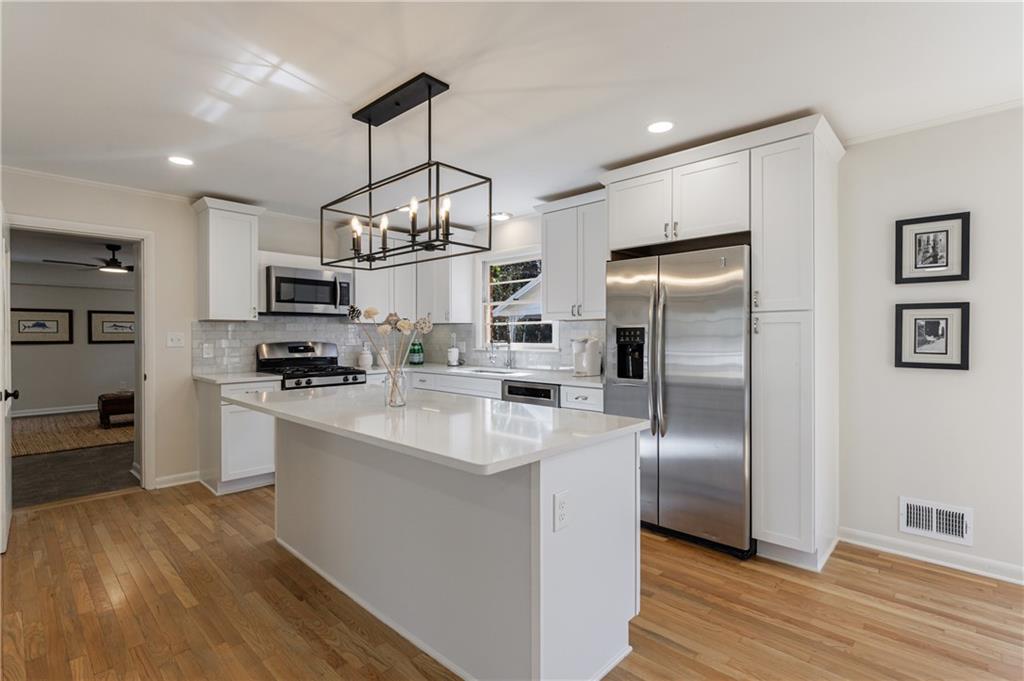 2996 Arrowood Drive East Point, GA 30344 - Photo 10 of 63 a kitchen with stainless steel appliances granite countertop a refrigerator a stove oven a sink dishwasher and a refrigerator with wooden floor