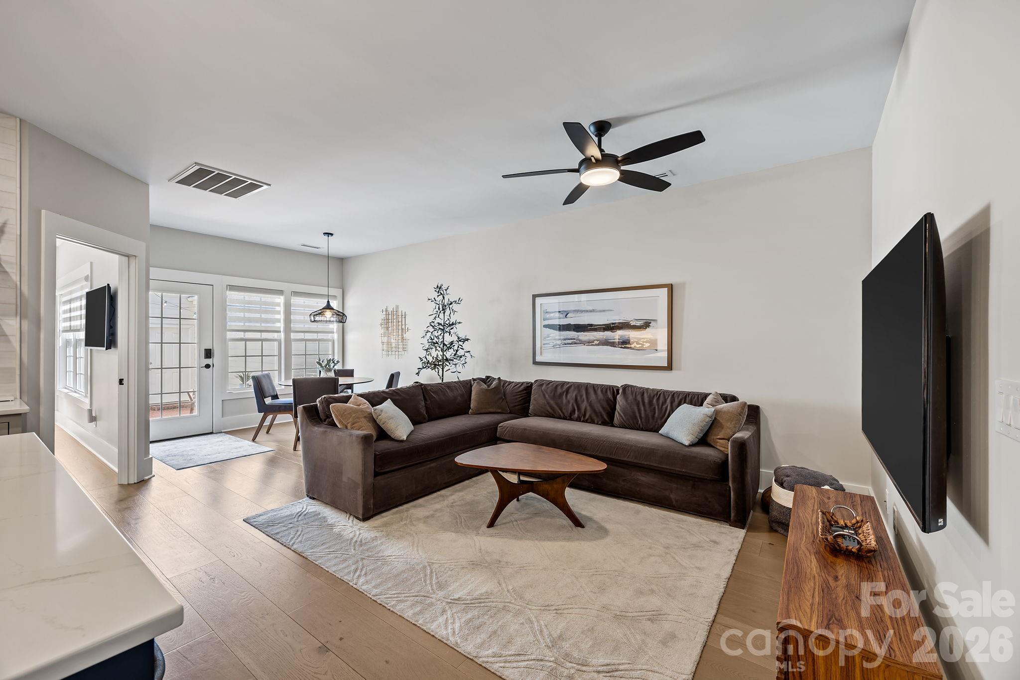 241 North Faulkner Way Davidson, NC 28036 - Photo 10 of 39 a living room with furniture a rug and a flat screen tv