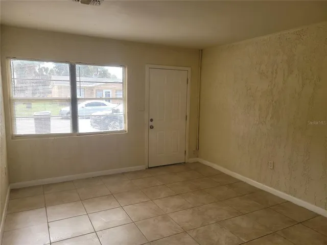 a view of an empty room with a window