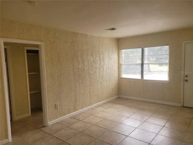 a view of an empty room with a window