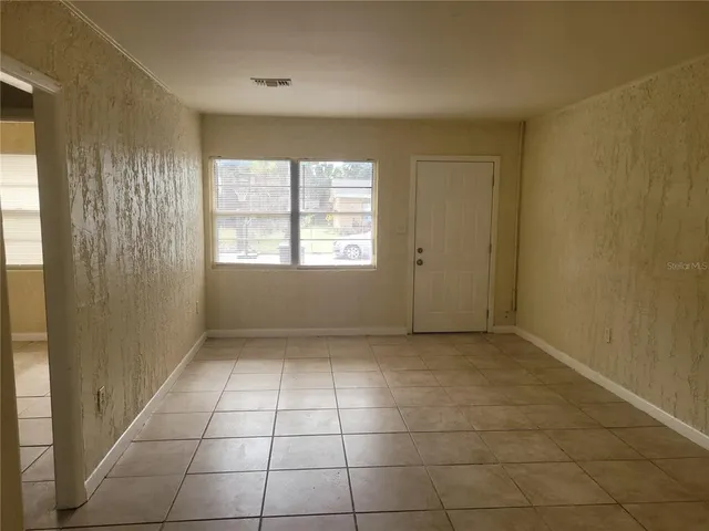 a view of an empty room with a window