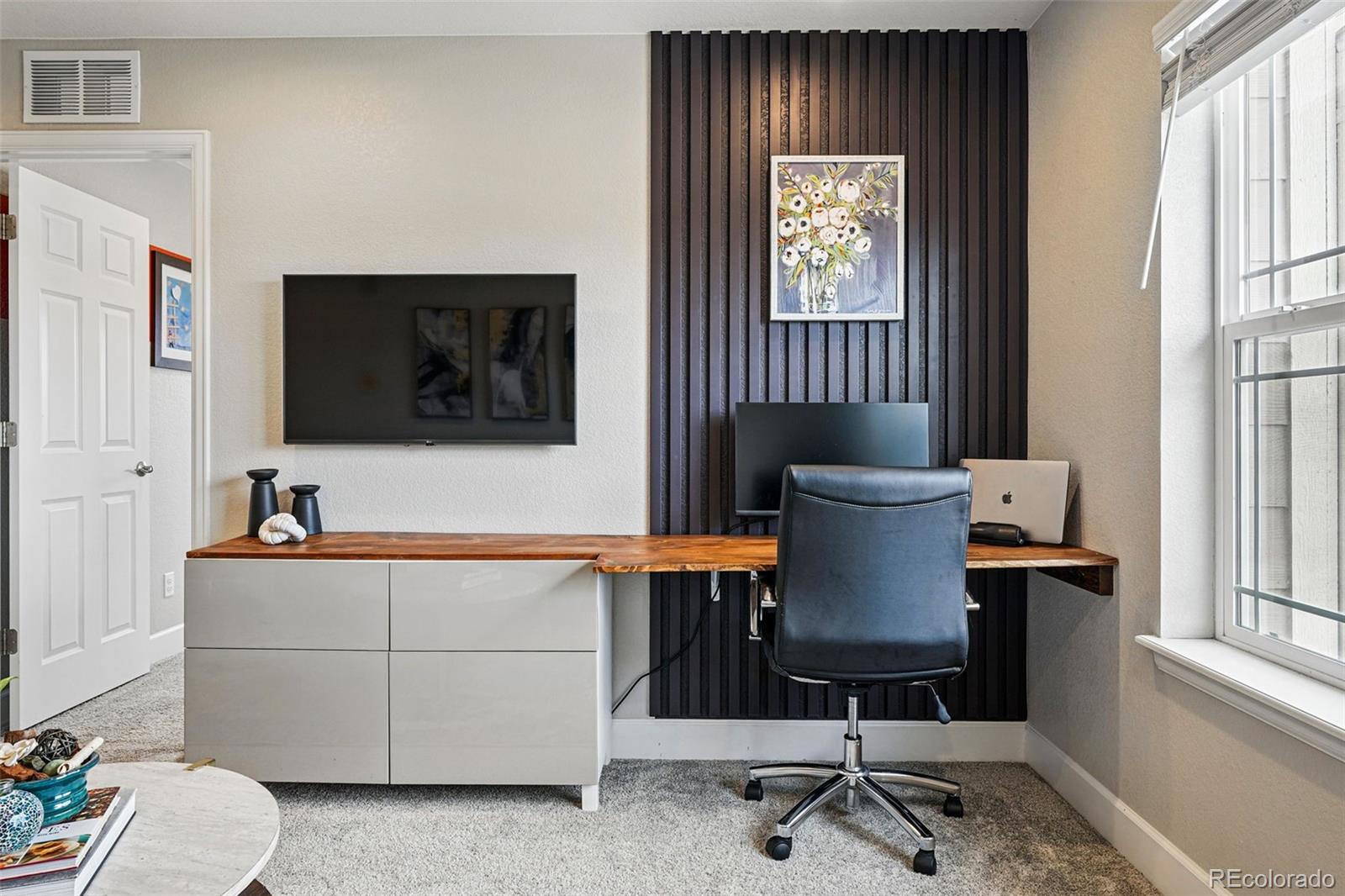 745 Penstemon Drive Henderson, CO 80640 - Photo 12 of 38 a living room with furniture and a flat screen tv