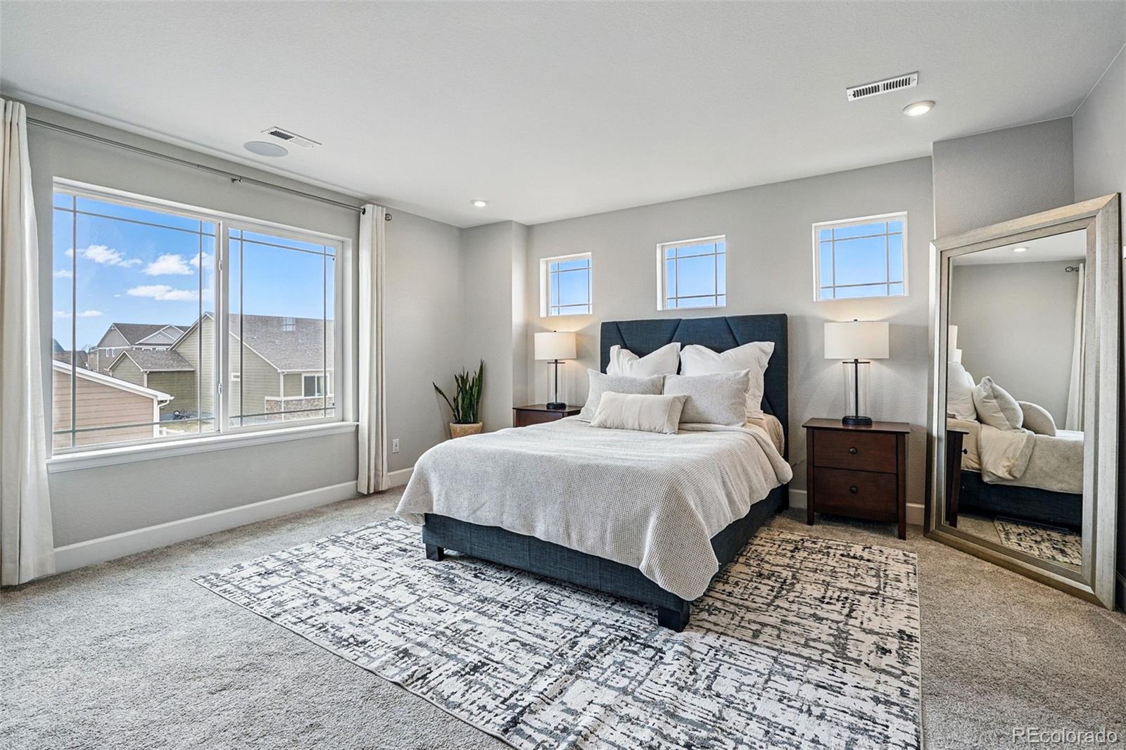 745 Penstemon Drive Henderson, CO 80640 - Photo 13 of 38 a bedroom with a large bed and a window