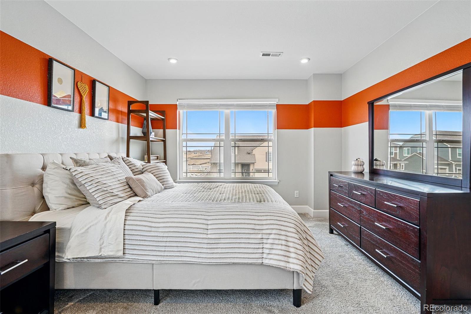 745 Penstemon Drive Henderson, CO 80640 - Photo 18 of 38 a bedroom with a bed and a large window