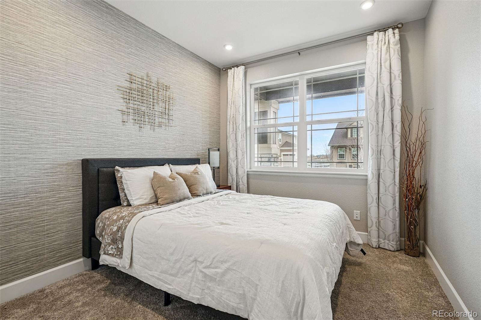 745 Penstemon Drive Henderson, CO 80640 - Photo 21 of 38 a bedroom with a large bed and a window