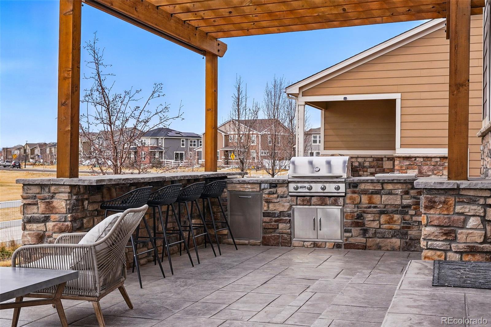 745 Penstemon Drive Henderson, CO 80640 - Photo 28 of 38 a view of a chairs and table in the back yard of the house