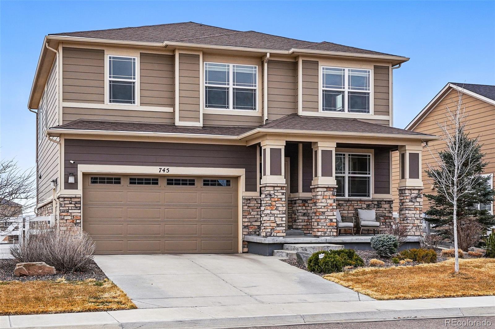 745 Penstemon Drive Henderson, CO 80640 - Photo 3 of 38 a front view of a house with yard