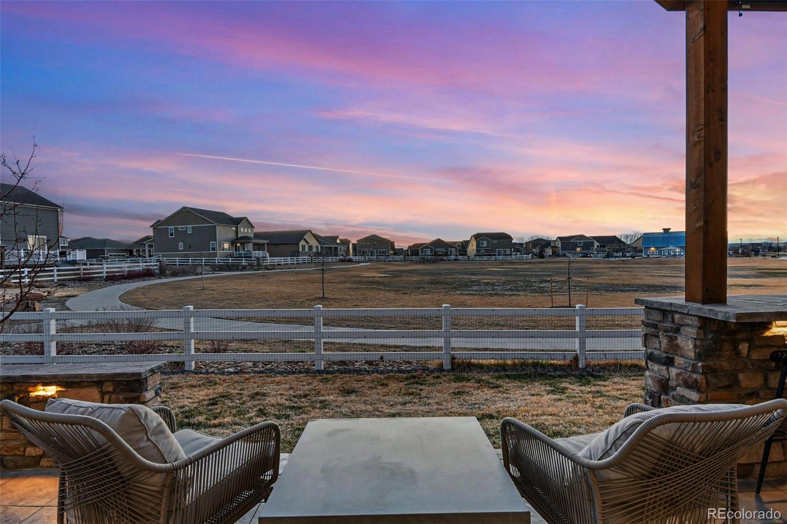 745 Penstemon Drive Henderson, CO 80640 - Photo 34 of 38 a view of a terrace with wooden floor and outdoor seating