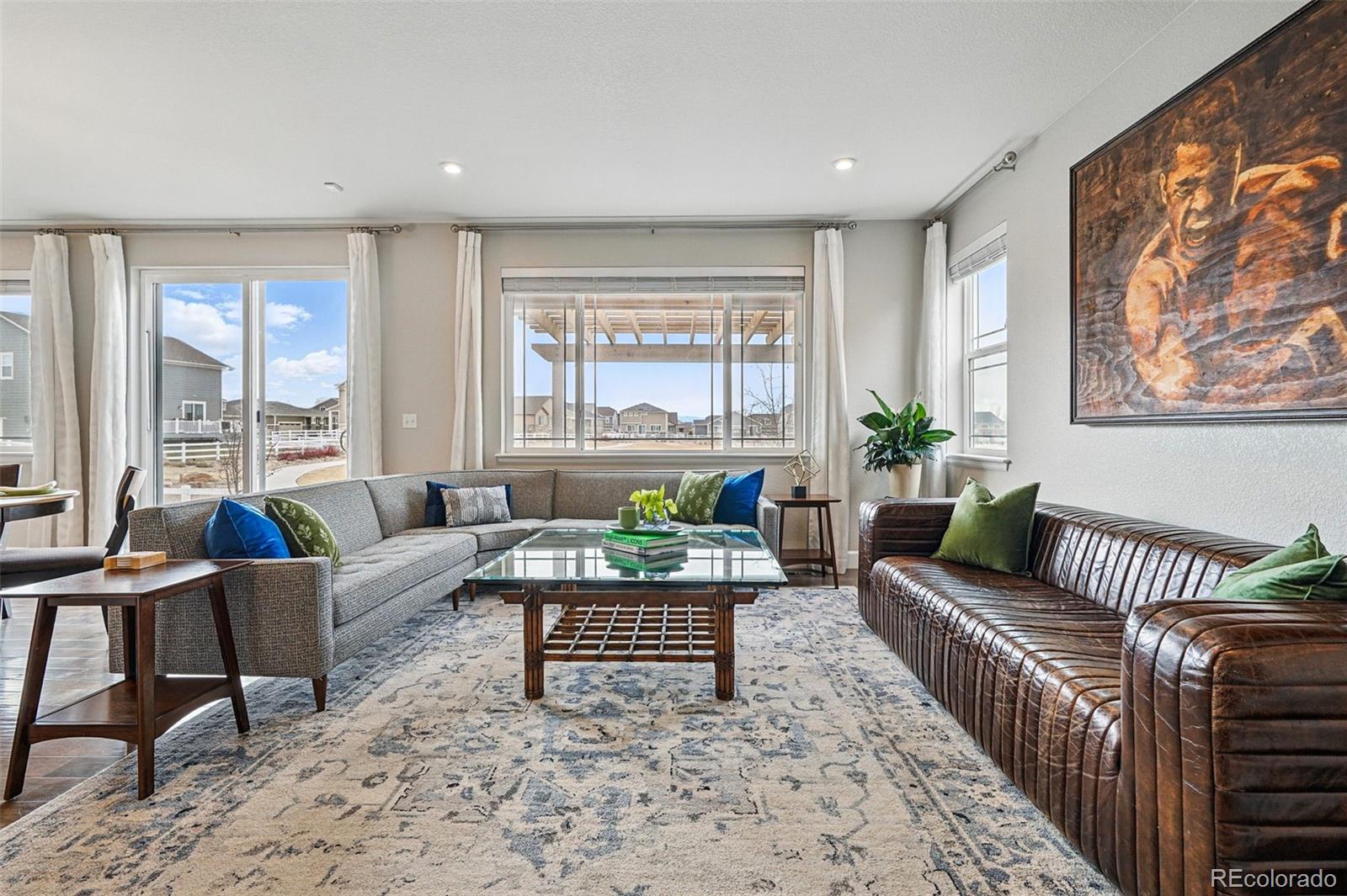 745 Penstemon Drive Henderson, CO 80640 - Photo 6 of 38 a living room with furniture and a large window