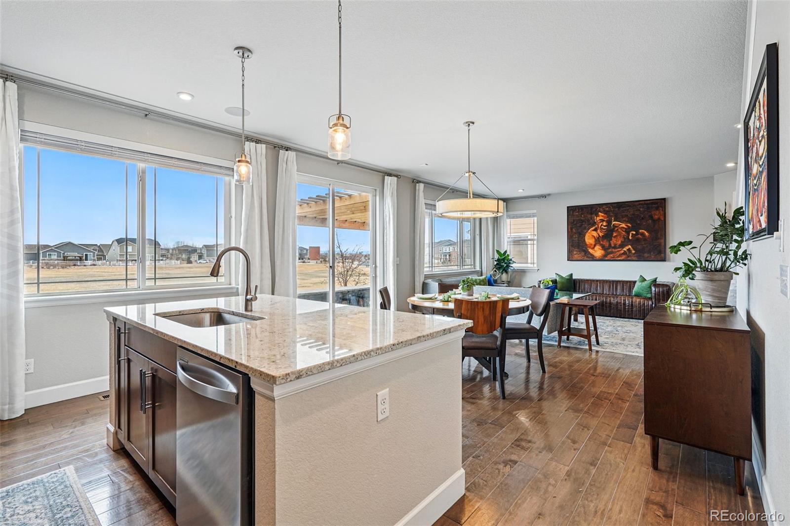 745 Penstemon Drive Henderson, CO 80640 - Photo 9 of 38 a kitchen with counter top space a sink appliances and cabinets