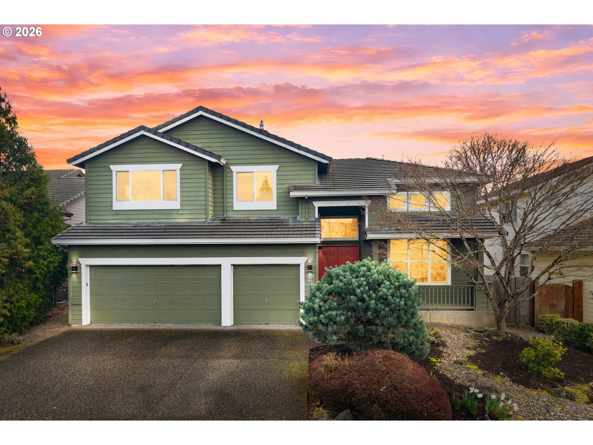 a front view of a house with a garden