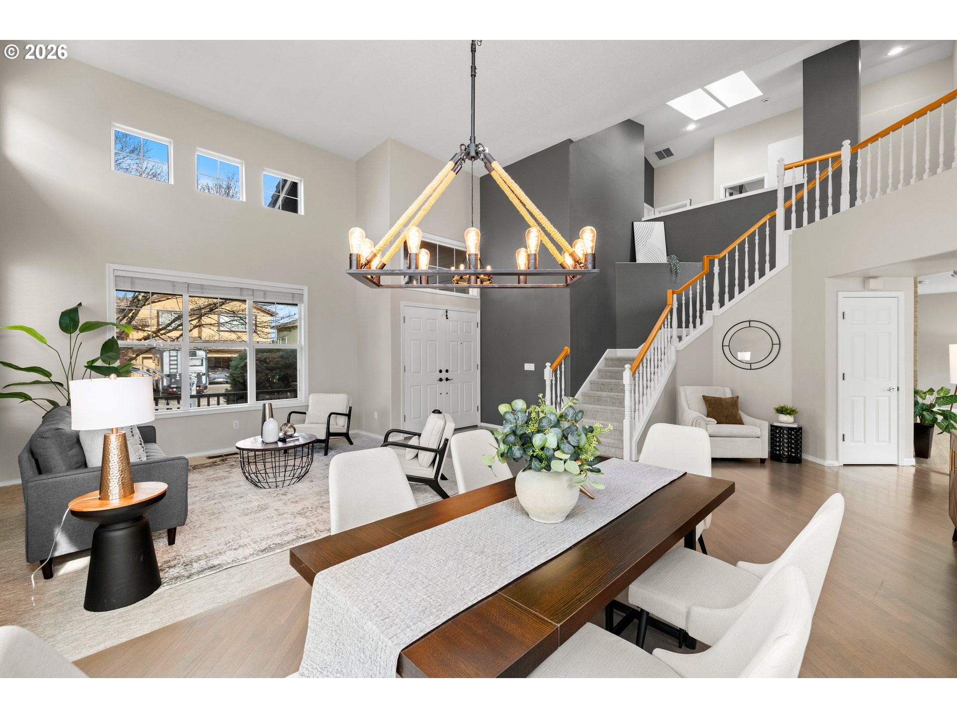 15542 Northwest Andalusian Way Portland, OR 97229 - Photo 12 of 48 a living room with furniture and a chandelier